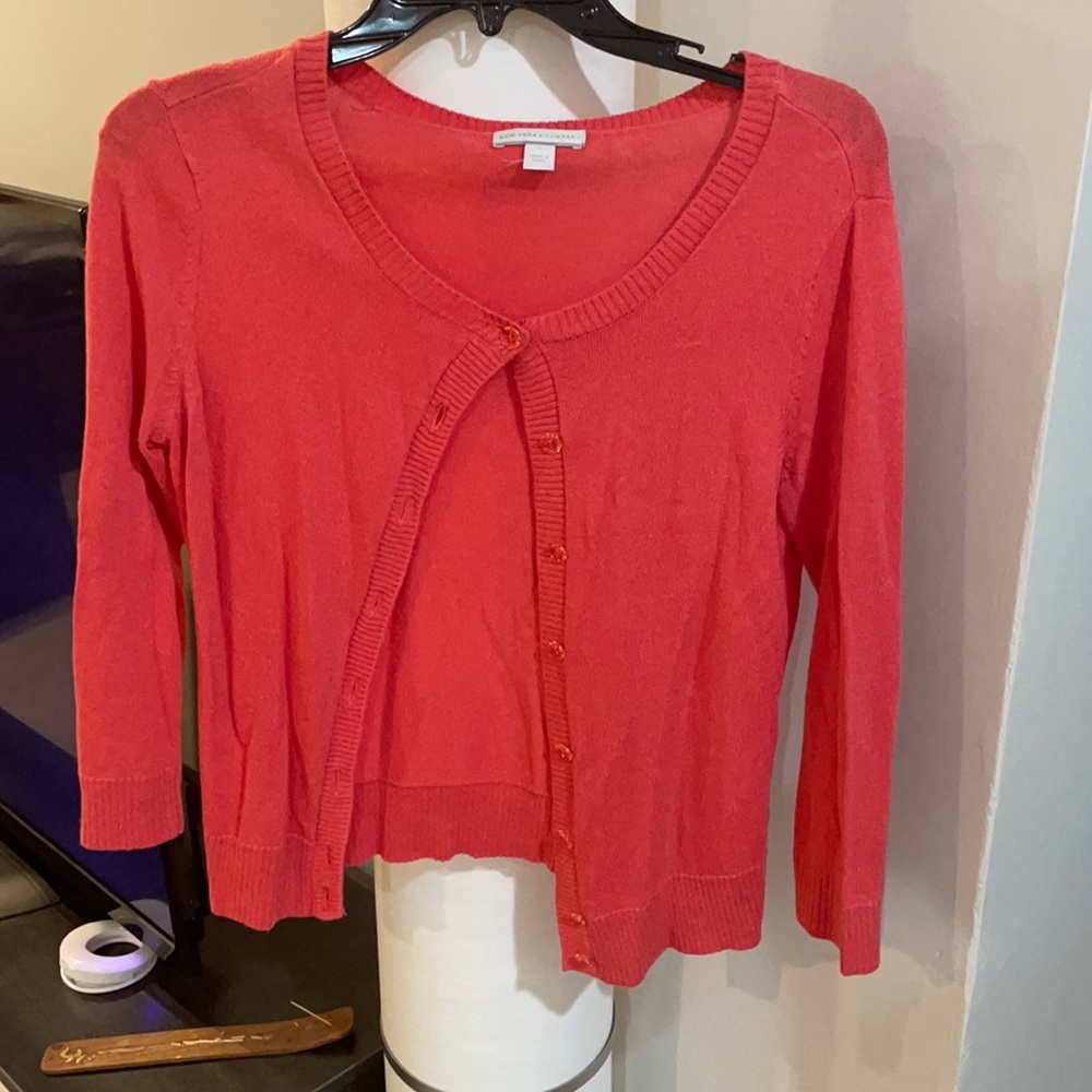 Really pretty pink sweater. The buttons are a clear pink too